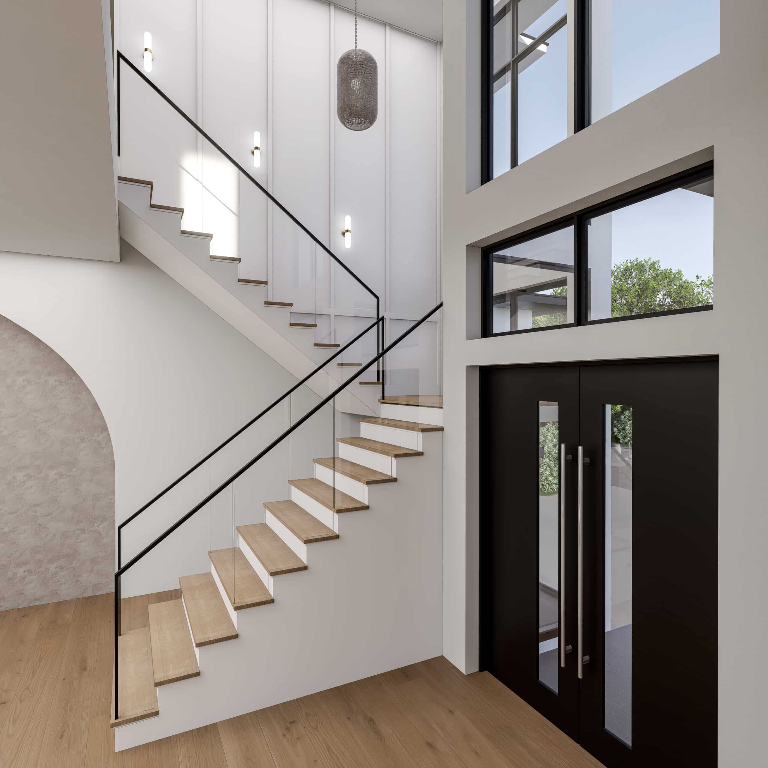 Two-story entry with a staircase and a glass front door
