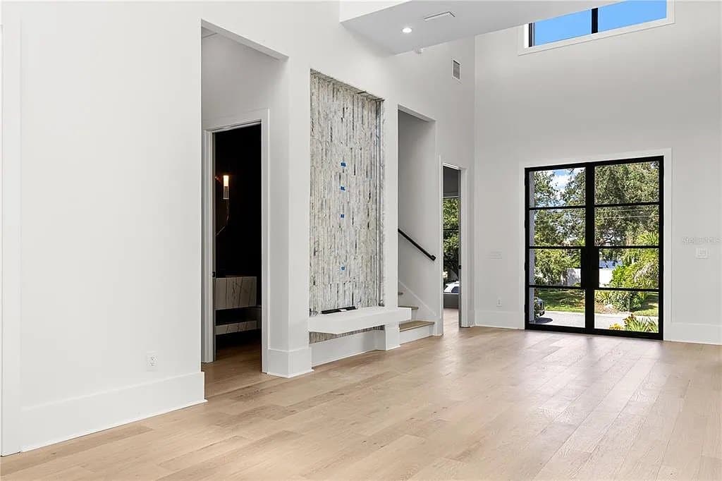 Entry hall with natural light and full-height glass in a luxury custom home